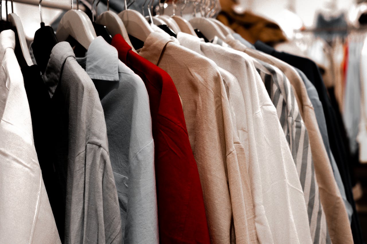 A rack of clothes with different colors and styles