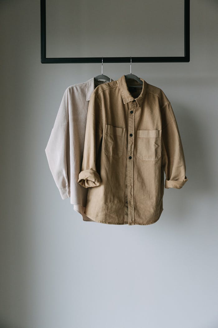 Brown Long Sleeve Shirt Hanging on Black Metal Rack